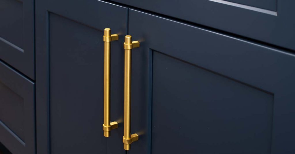 Black shaker cabinets with gold tone handles.