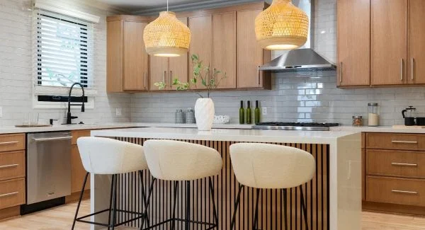 Modern kitchen with white oak cabinets and subway tile backsplash.