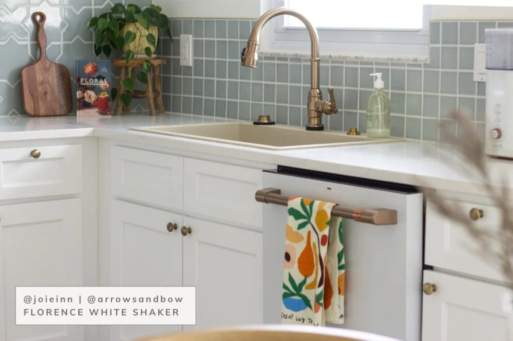 White kitchen with blind corner base cabinets in corner.