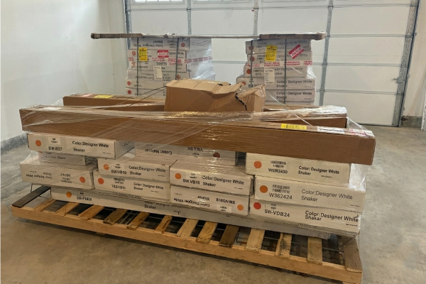 Cabinets in flat packaging in a warehouse.