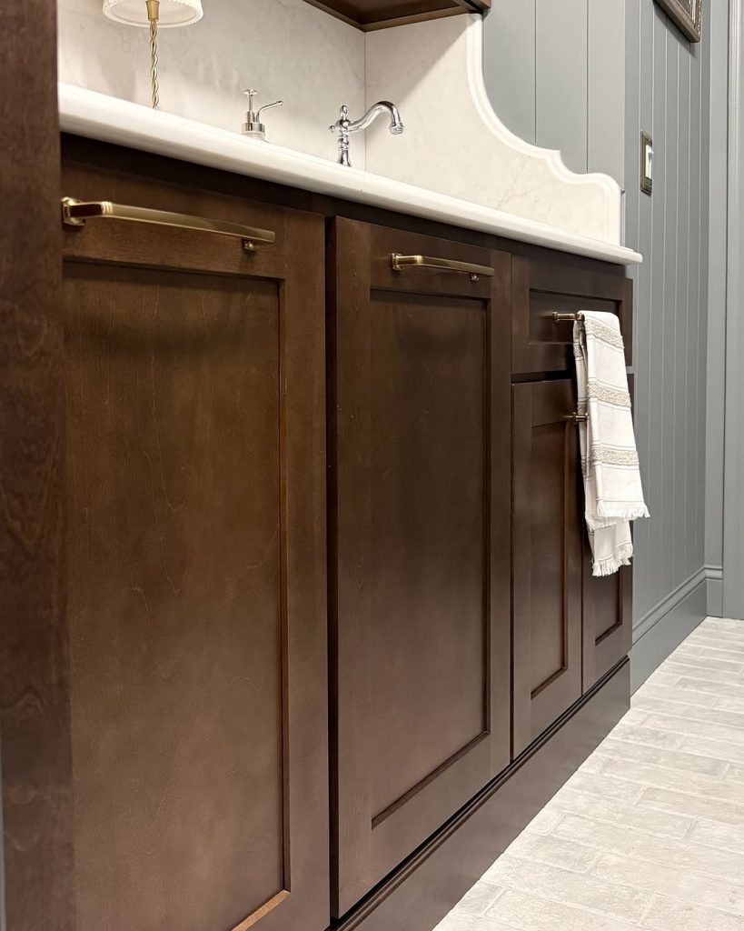 Dark wood shaker cabinets with gold tone hardware.